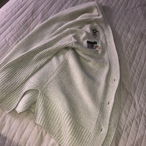 A Graphic with pictures with a all gray Sweater